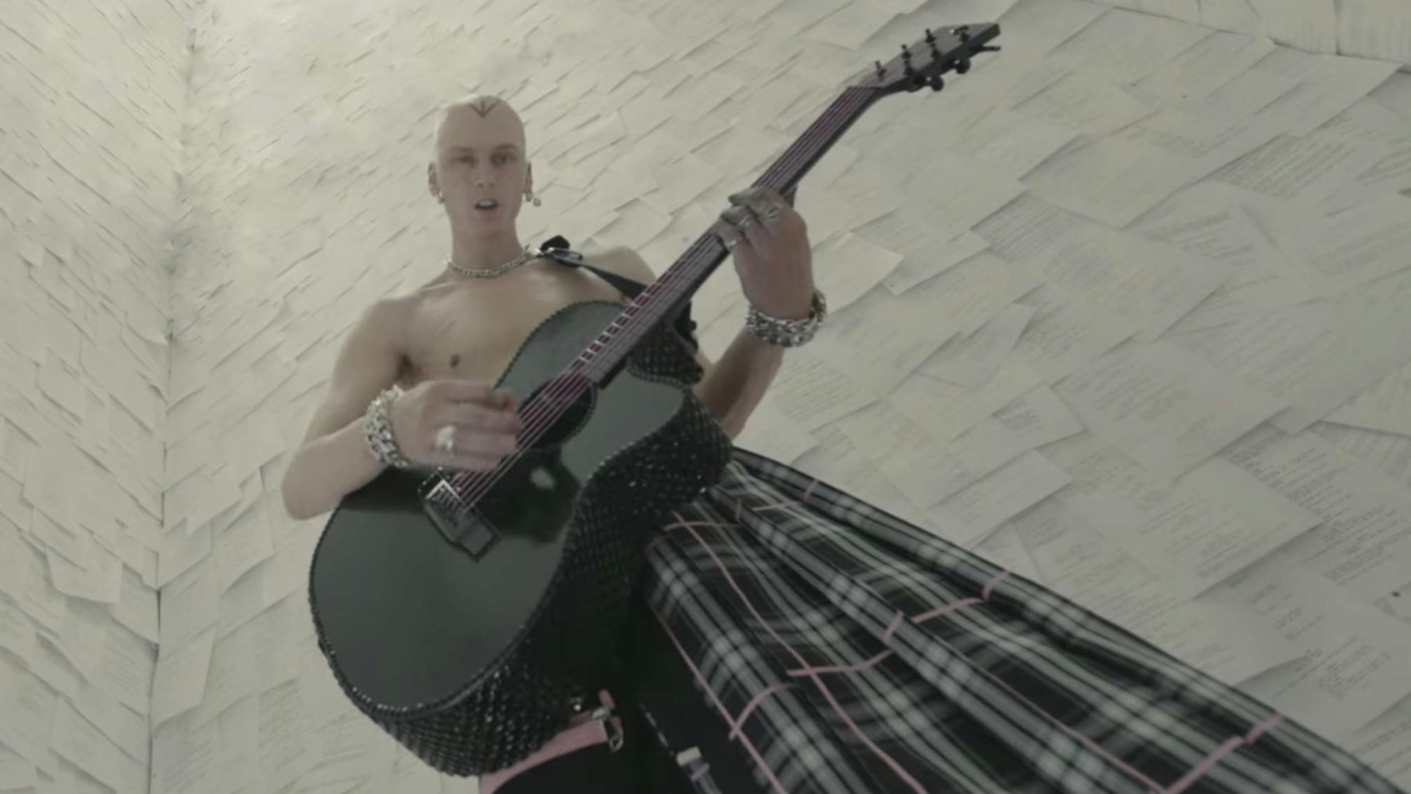 Machine Gun Kelly shows off giant skull tattoo and shaved head in new music video, papercuts