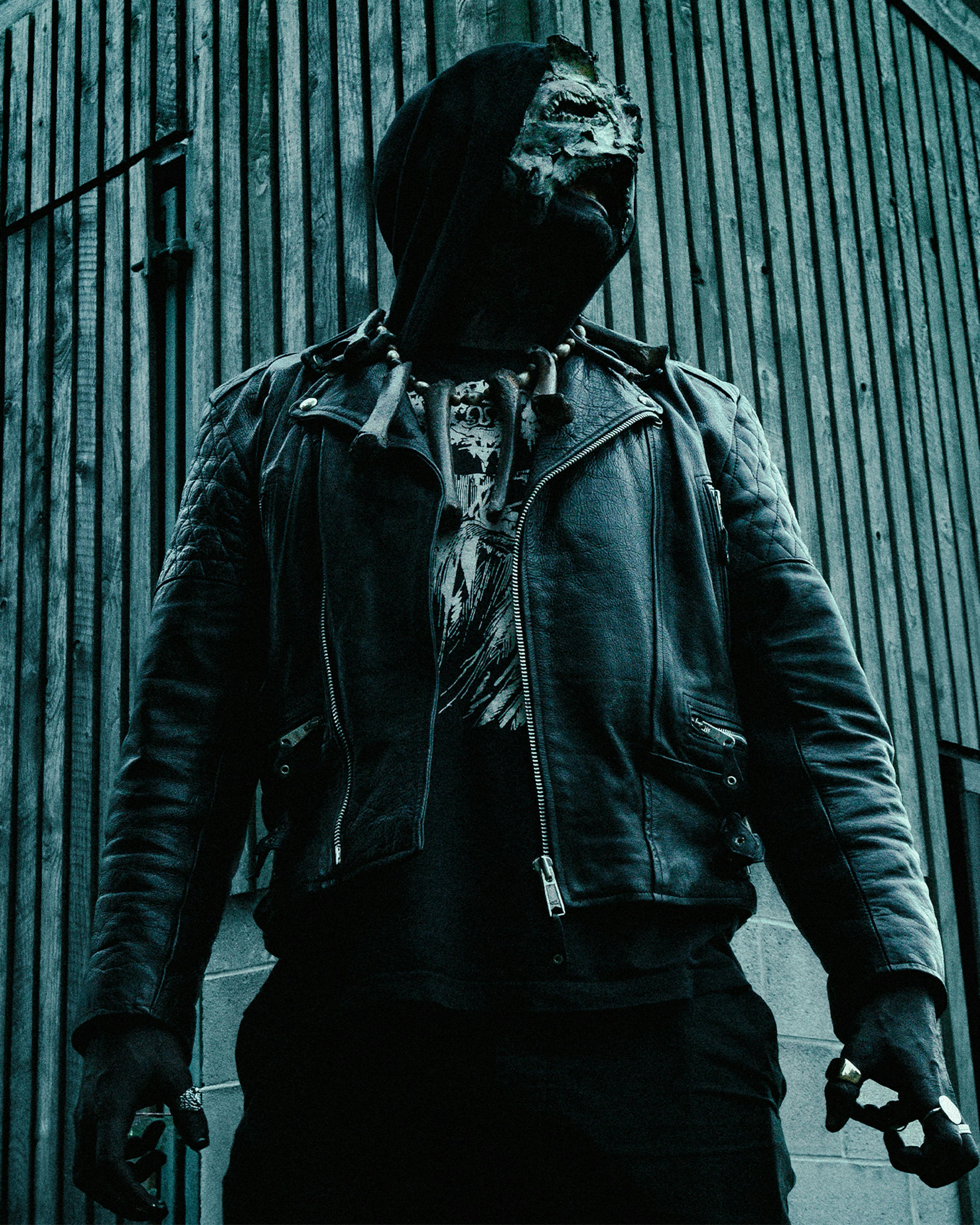 A photo of singer AV from black metal band Abduction in his mask, bones and leather jacket